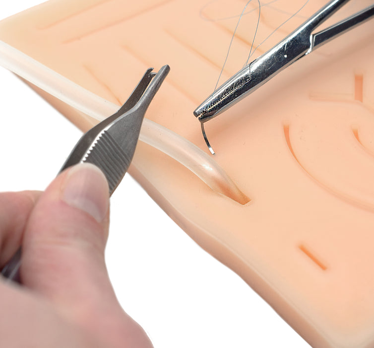 suturing simulated wound on suture pad
