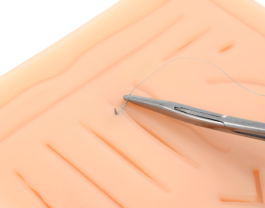 suturing simulated wound on suture pad